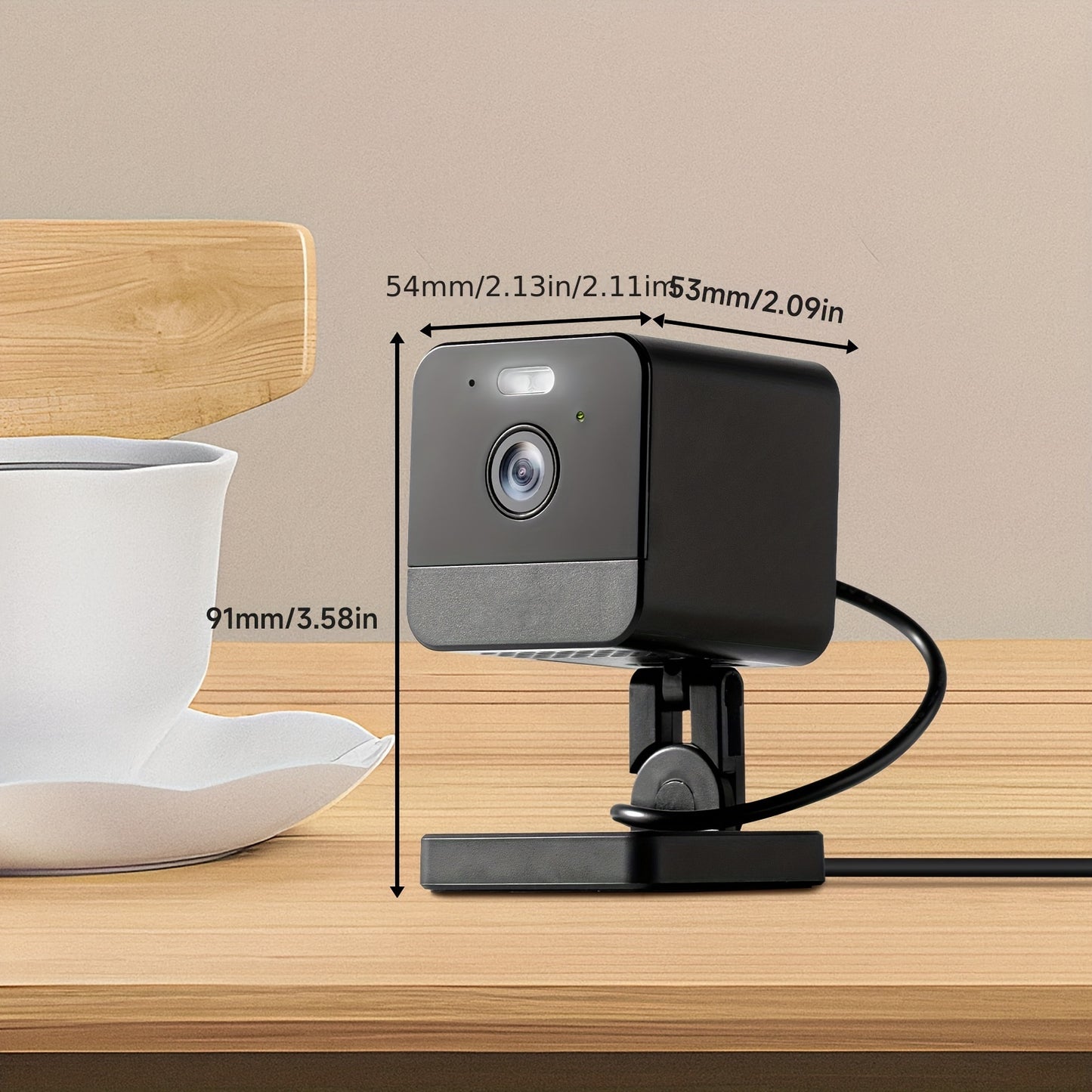 Black security camera with measurements on a wooden surface