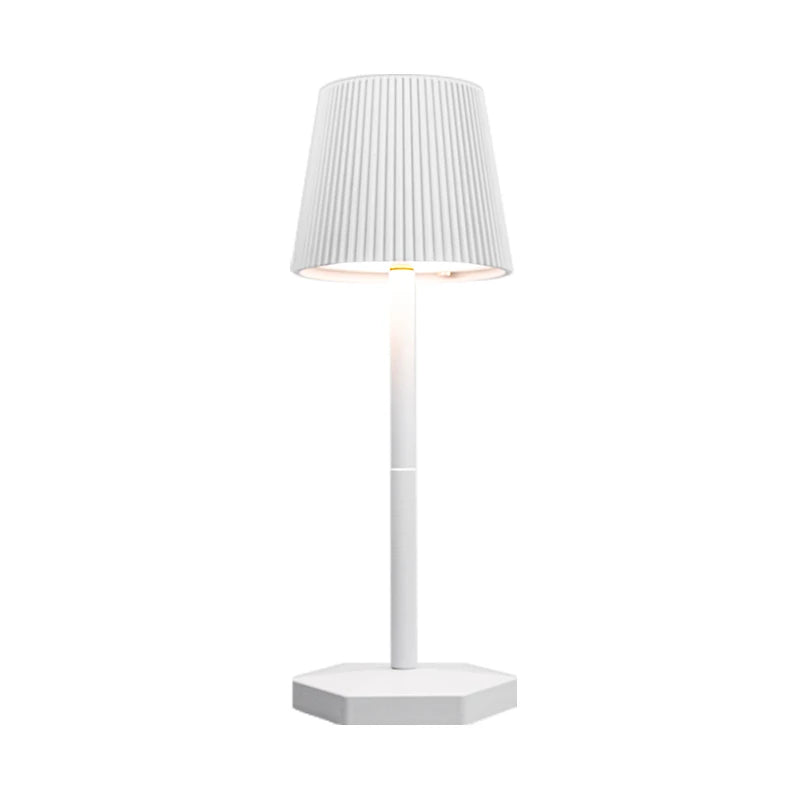 White table lamp with pleated shade on a white background
